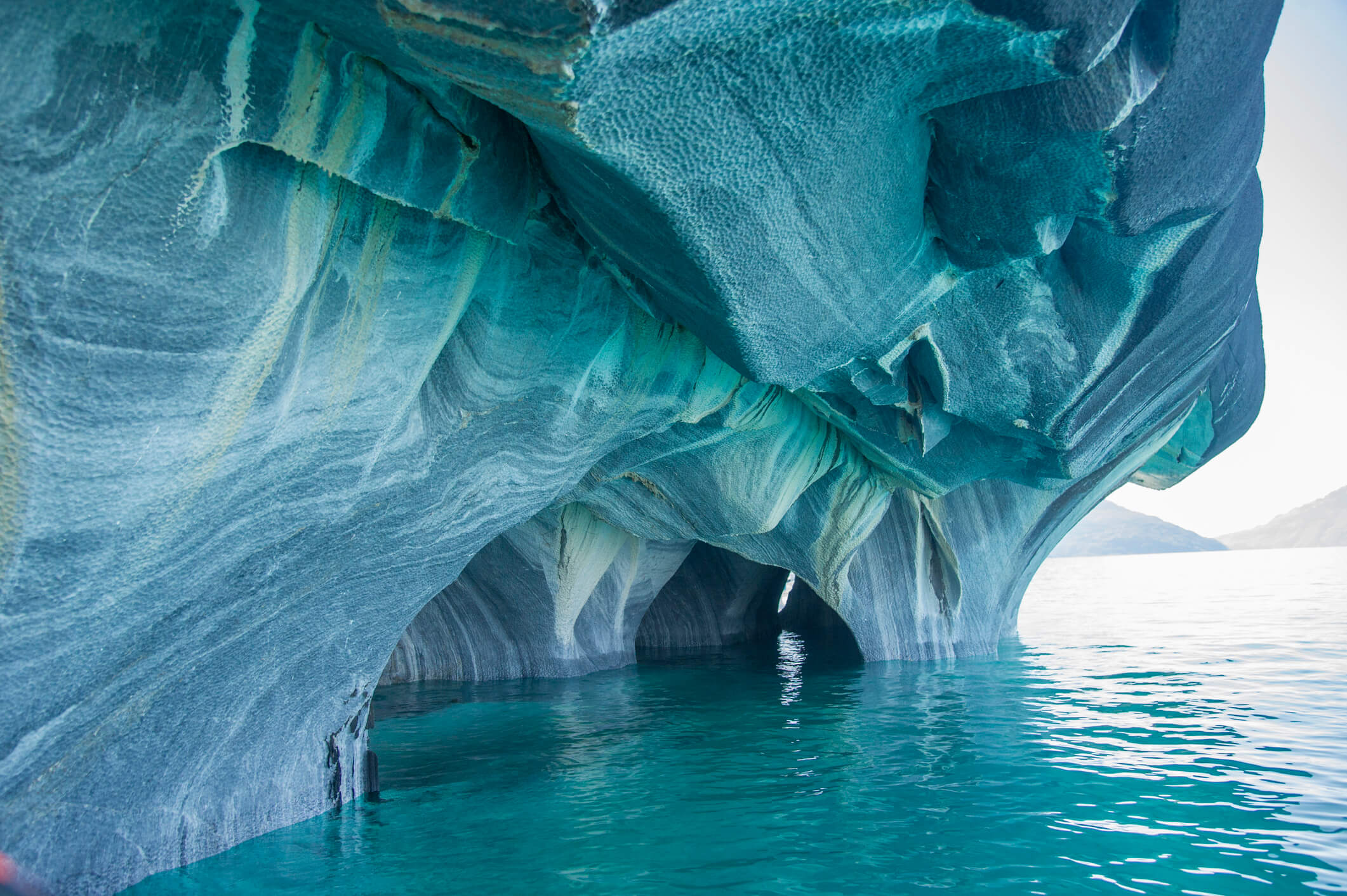 Seaside caves of marble carved out by lapping water. 