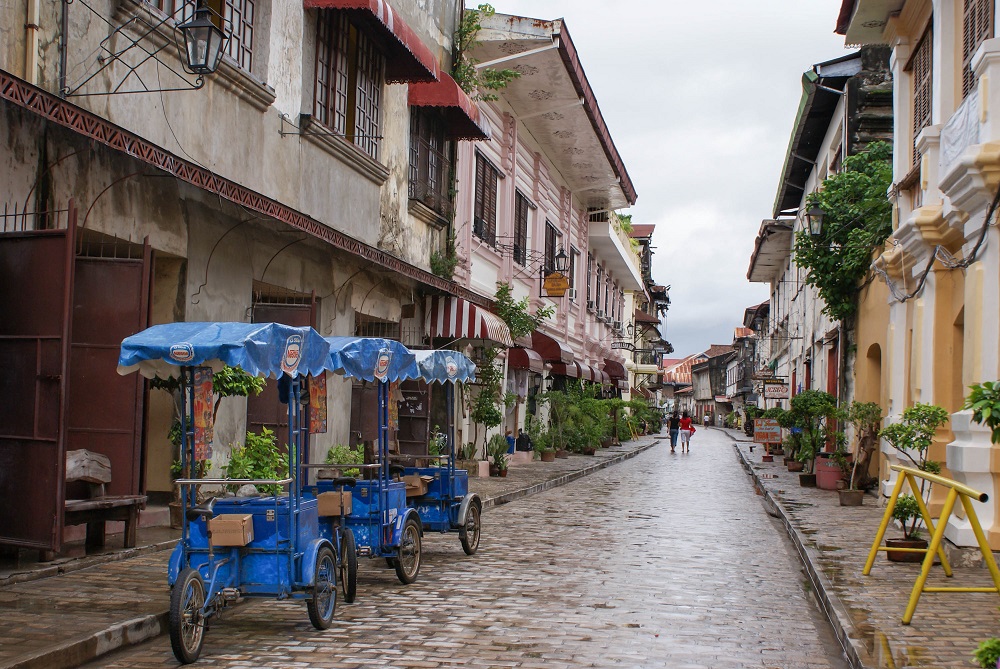 Cobblestone streets of Vigan City with tricycles