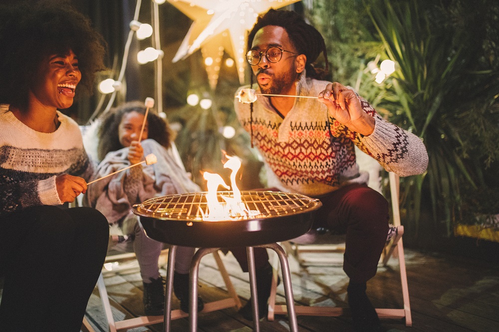 People roasting marshmallows around the campfire