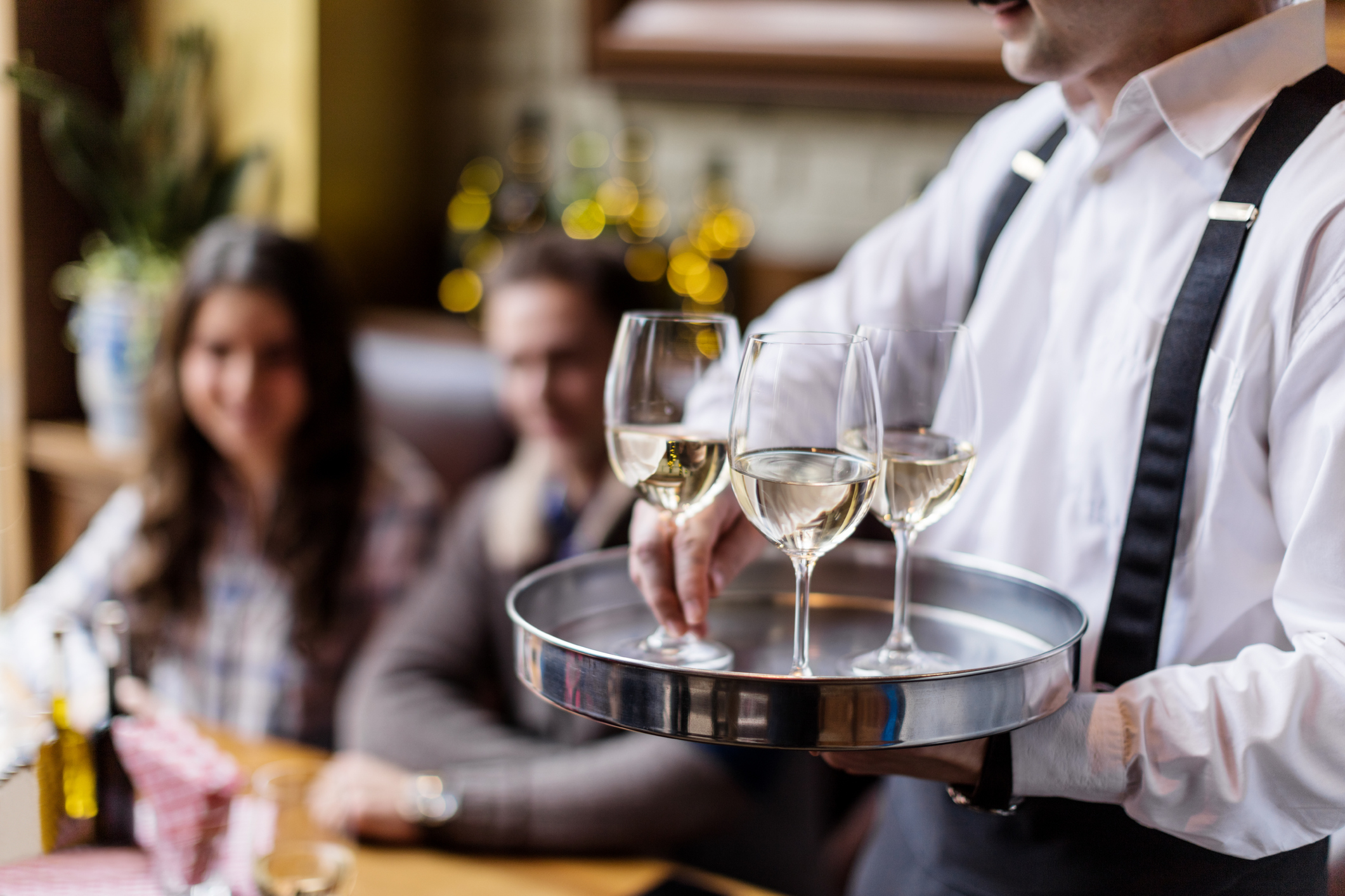 Waiter serving wine