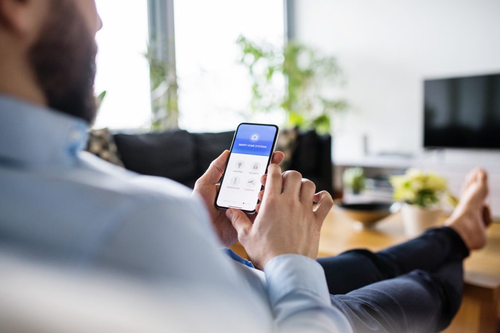 Man using phone to control environment