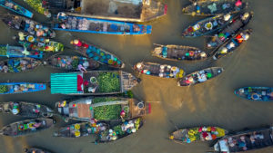 Areal of local people buying and selling colorful produce from boats at a tour the floating market travel in China.